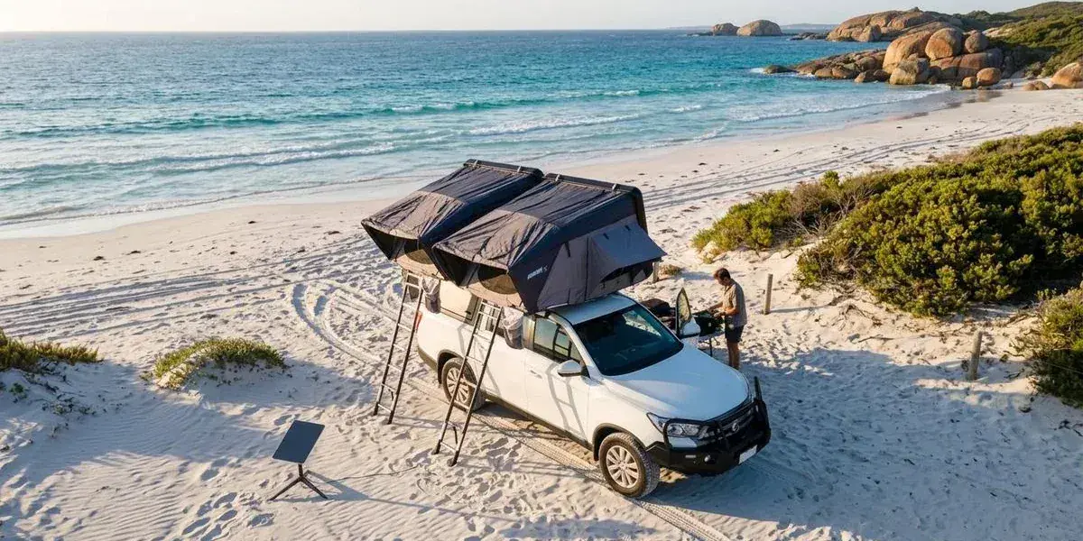 An aerial view of a 4WD camper at a beachside campsite on the Western Australian coast